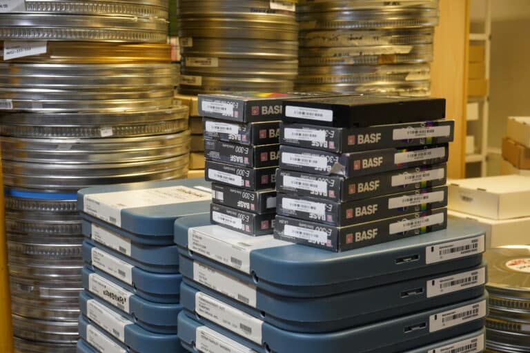 Esker med filmruller og videokassetter stablet